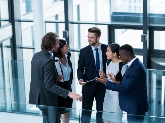 Four doctors networking at a meeting
